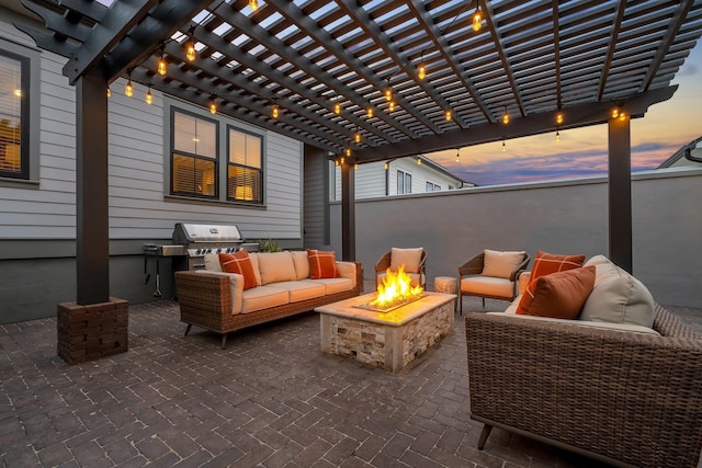 patio terrace at dusk with grilling area, a pergola, and an outdoor living space with a fire pit