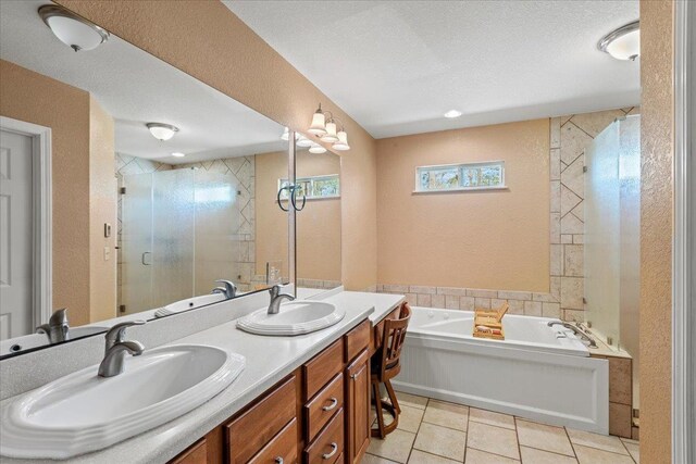 full bathroom featuring tile patterned flooring, a stall shower, a bath, a textured ceiling, and a sink