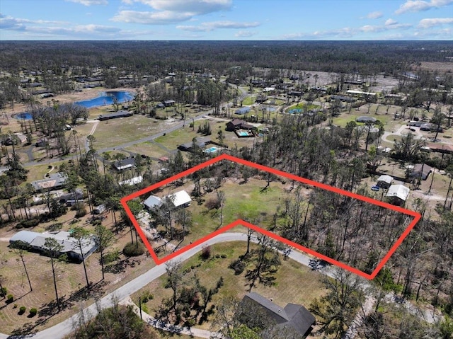 drone / aerial view featuring a view of trees