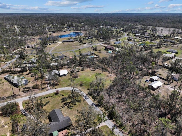 birds eye view of property with a forest view