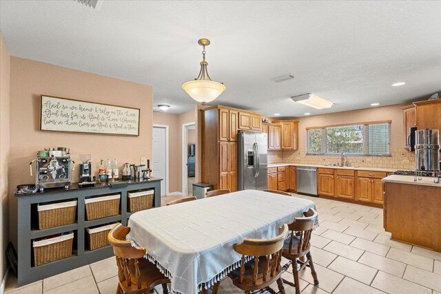 dining area featuring light tile patterned flooring and recessed lighting