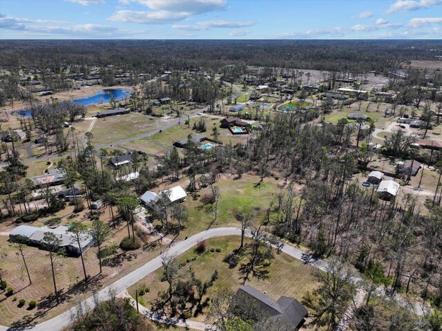 aerial view with a forest view and a water view