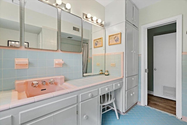 921 Forest Dr, Quincy, FL 32351 - bathroom with vanity, tile patterned flooring, and tasteful backsplash