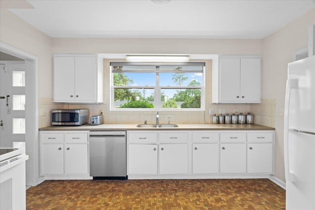 921 Forest Dr, Quincy, FL 32351 - kitchen with stainless steel appliances, tasteful backsplash, white cabinets, and light countertops