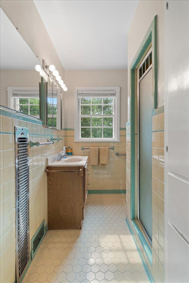 921 Forest Dr, Quincy, FL 32351 - full bath featuring tile walls, vanity, tile patterned flooring, a shower stall, and a wainscoted wall