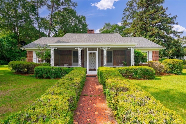 921 Forest Dr, Quincy, FL 32351 - ranch-style home featuring brick siding, a front yard, covered porch, and a chimney