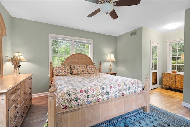 921 Forest Dr, Quincy, FL 32351 - bedroom with dark wood finished floors, multiple windows, and a ceiling fan