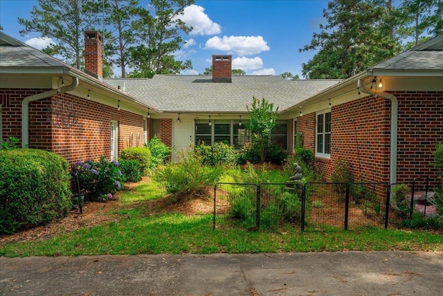 921 Forest Dr, Quincy, FL 32351 - view of front of home featuring brick siding, a chimney, and a shingled roof