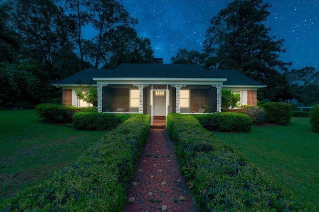 921 Forest Dr, Quincy, FL 32351 - view of front of house featuring covered porch, a front yard, and brick siding