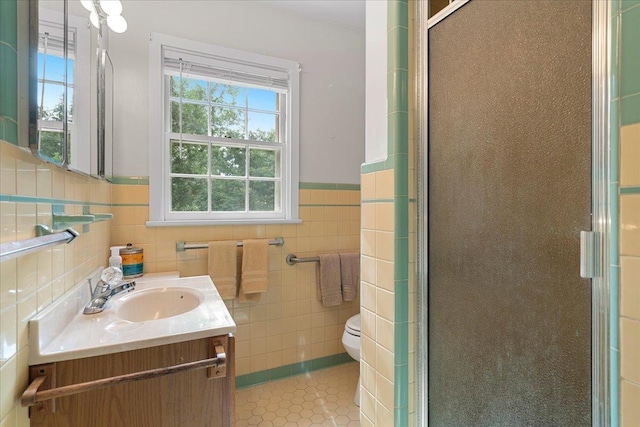 921 Forest Dr, Quincy, FL 32351 - bathroom featuring a stall shower, tile walls, vanity, tile patterned flooring, and a wainscoted wall