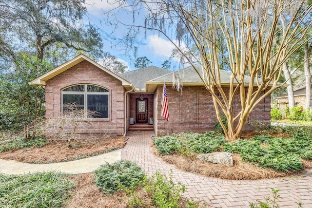 single story home with brick siding and roof with shingles