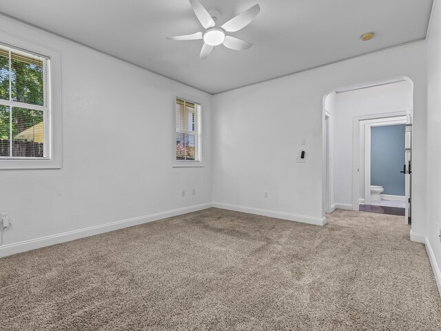 2424 Old Saint Augustine Rd, Tallahassee, FL 32301 - carpeted empty room featuring a ceiling fan, arched walkways, and a smoke detector