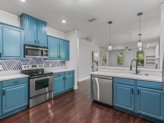 2424 Old Saint Augustine Rd, Tallahassee, FL 32301 - kitchen featuring appliances with stainless steel finishes, blue cabinetry, recessed lighting, light countertops, and crown molding