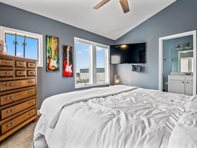 bedroom with lofted ceiling, ensuite bathroom, a ceiling fan, and carpet flooring