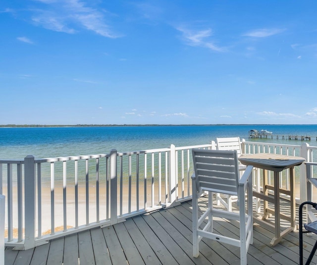 wooden terrace featuring a water view