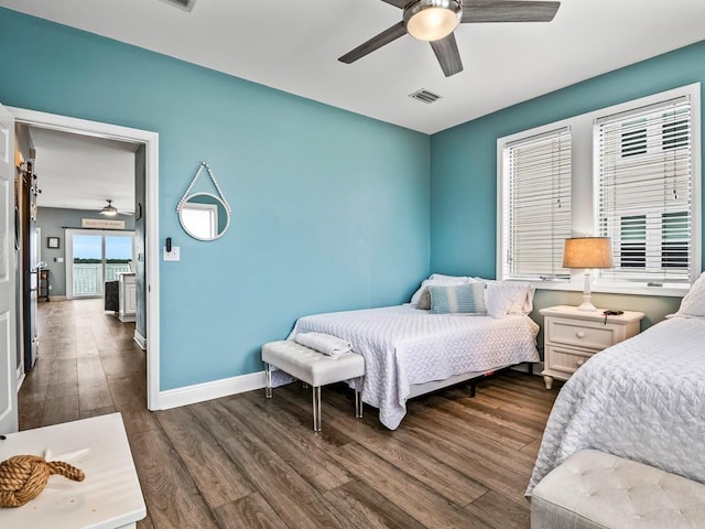 bedroom featuring dark wood-type flooring, baseboards, and ceiling fan
