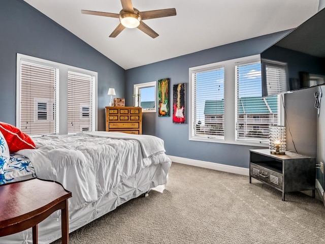 bedroom with lofted ceiling, baseboards, carpet floors, and a ceiling fan