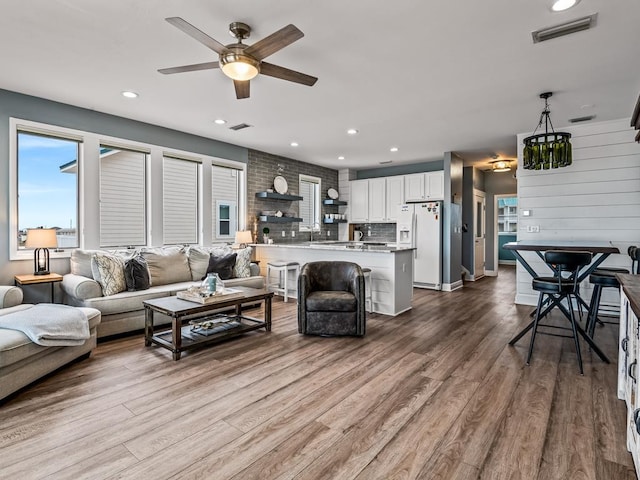 living room featuring ceiling fan, dark wood finished floors, and recessed lighting