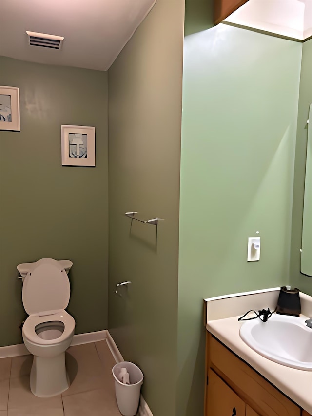 bathroom with vanity, tile patterned flooring, and toilet