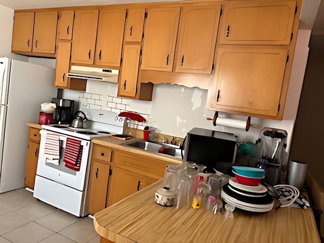 kitchen with sink, white appliances, and light tile patterned flooring