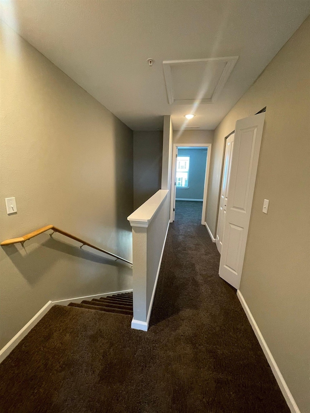 2281 Del Carmel Way, Tallahassee, FL 32303 - hallway with dark colored carpet, attic access, and an upstairs landing