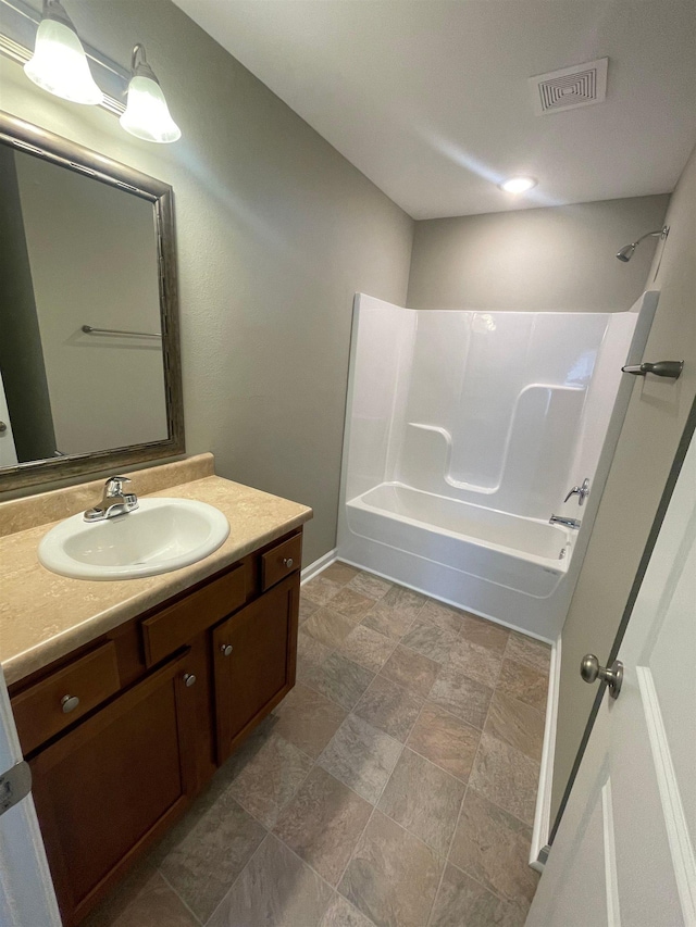 2281 Del Carmel Way, Tallahassee, FL 32303 - full bath featuring vanity, washtub / shower combination, and stone finish flooring