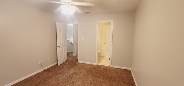 unfurnished bedroom with carpet floors, ceiling fan, and connected bathroom