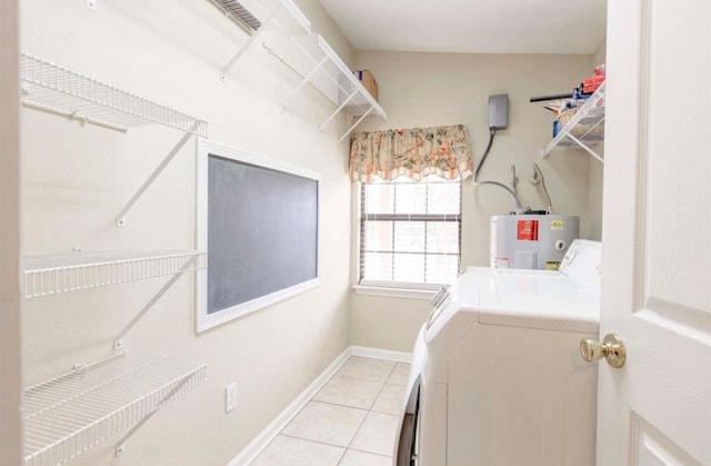 laundry area with water heater, light tile patterned floors, and washer and clothes dryer