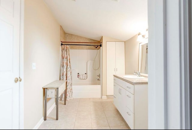 bathroom with vanity, lofted ceiling, shower / tub combo, and tile patterned floors