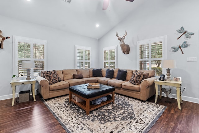 living room featuring ceiling fan, dark wood-type flooring, high vaulted ceiling, and a healthy amount of sunlight