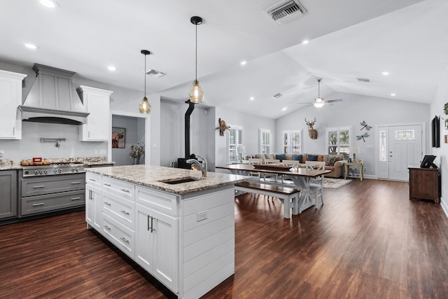 kitchen featuring sink, custom exhaust hood, white cabinetry, dark hardwood / wood-style floors, and light stone countertops