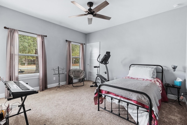 carpeted bedroom with ceiling fan and multiple windows