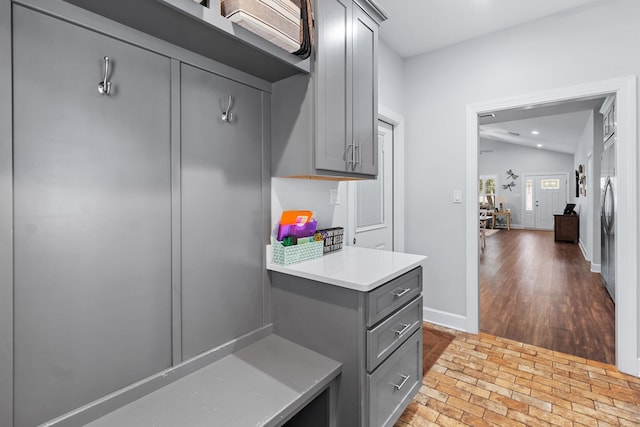 kitchen with vaulted ceiling and gray cabinetry