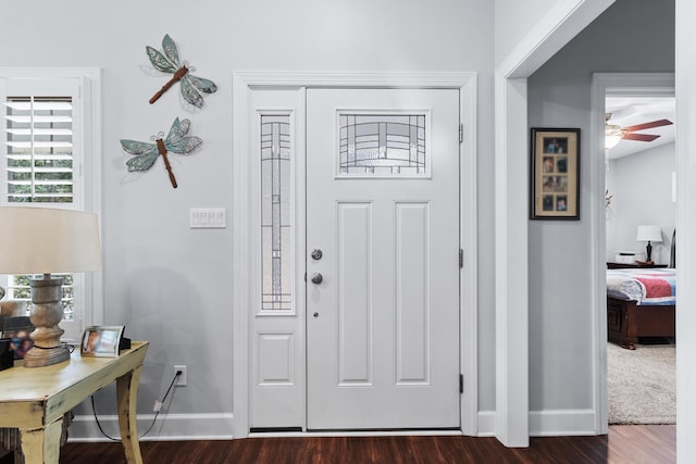 foyer entrance with dark wood-type flooring and ceiling fan