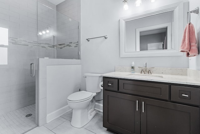 bathroom with vanity, a shower with shower door, tile patterned floors, and toilet