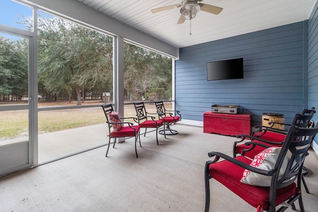 sunroom / solarium with a wealth of natural light and ceiling fan