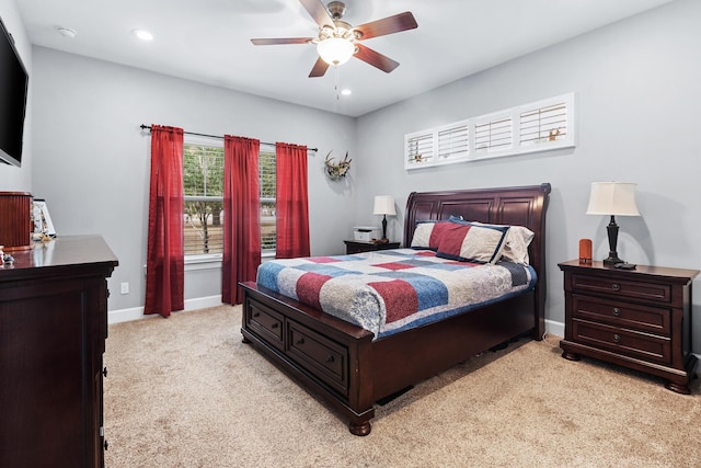 bedroom featuring light colored carpet and ceiling fan