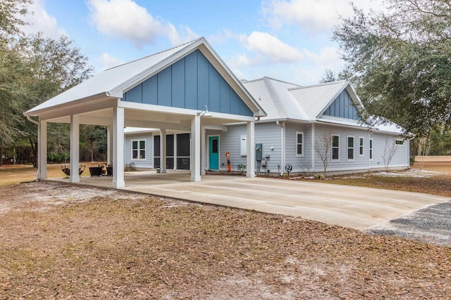 back of house featuring a carport