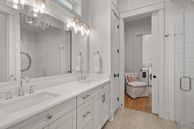 4318 Terebinth Trl, Tallahassee, FL 32317 - bathroom featuring washing machine and dryer, a shower stall, double vanity, and ensuite bathroom