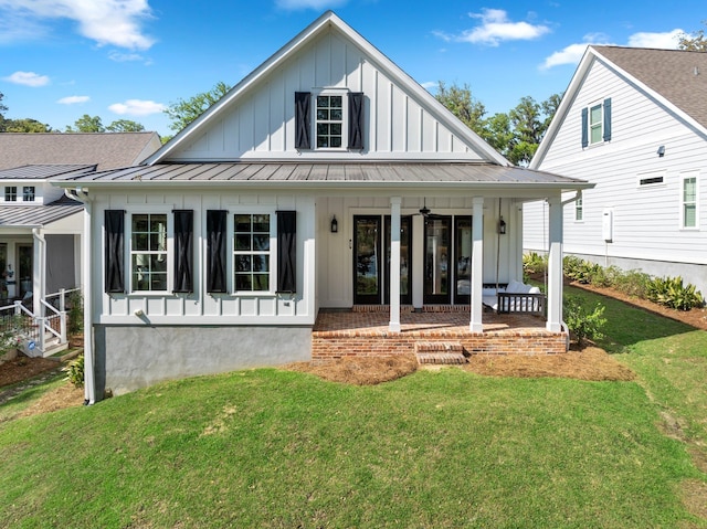 4318 Terebinth Trl, Tallahassee, FL 32317 - view of front of property featuring board and batten siding, a standing seam roof, a porch, a front yard, and metal roof