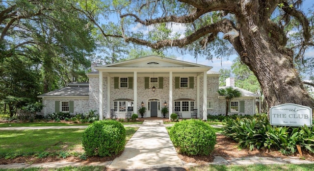 4318 Terebinth Trl, Tallahassee, FL 32317 - neoclassical home with brick siding, a chimney, and a front yard