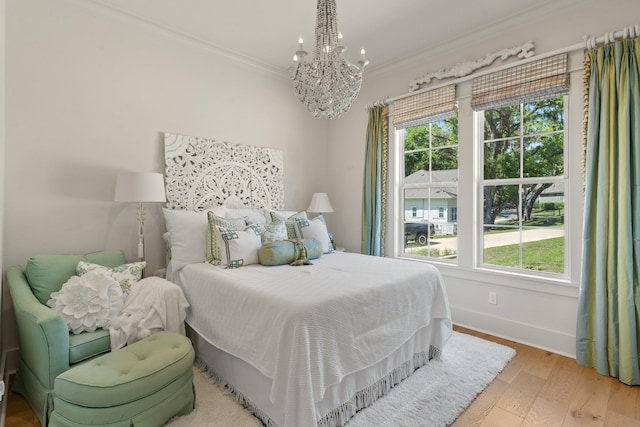 4318 Terebinth Trl, Tallahassee, FL 32317 - bedroom featuring a chandelier, multiple windows, ornamental molding, baseboards, and wood finished floors