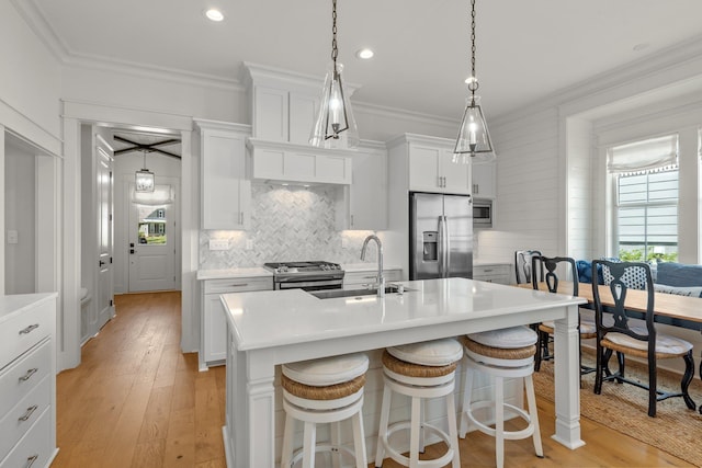 4318 Terebinth Trl, Tallahassee, FL 32317 - kitchen with stainless steel appliances, crown molding, a sink, light wood-style flooring, and light countertops
