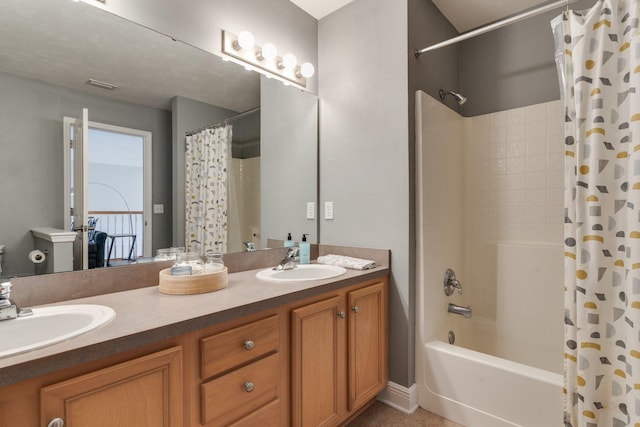 bathroom featuring shower / bathtub combination with curtain, tile patterned floors, and vanity