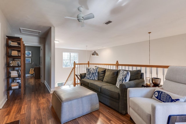 living room featuring dark hardwood / wood-style flooring and ceiling fan