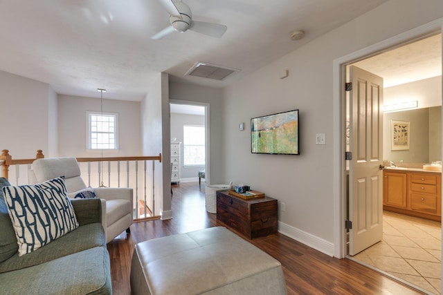 living room featuring ceiling fan and light hardwood / wood-style flooring