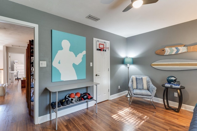 living area with hardwood / wood-style floors and ceiling fan