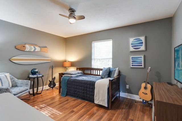 bedroom with ceiling fan and dark hardwood / wood-style floors