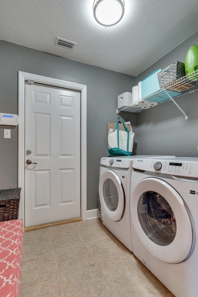 washroom with washer and dryer