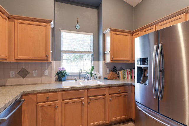 kitchen featuring sink, tasteful backsplash, and appliances with stainless steel finishes